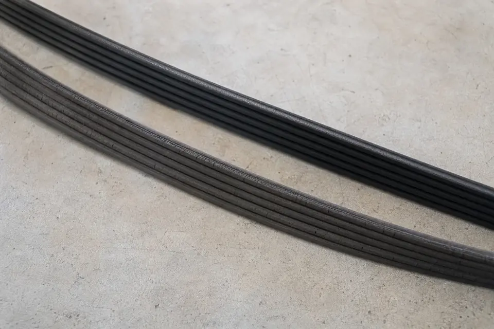 Serpentine belt laid out on a concrete surface