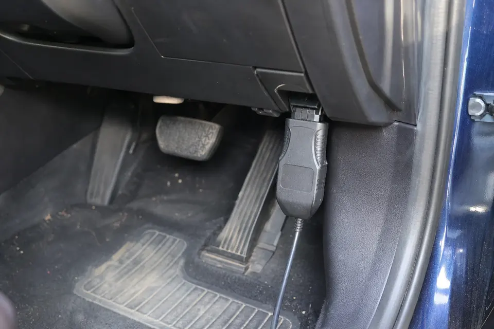 OBD diagnostic connector beneath a car dashboard