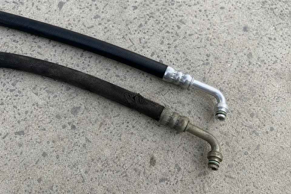 Worn and replacement power steering hoses side by side