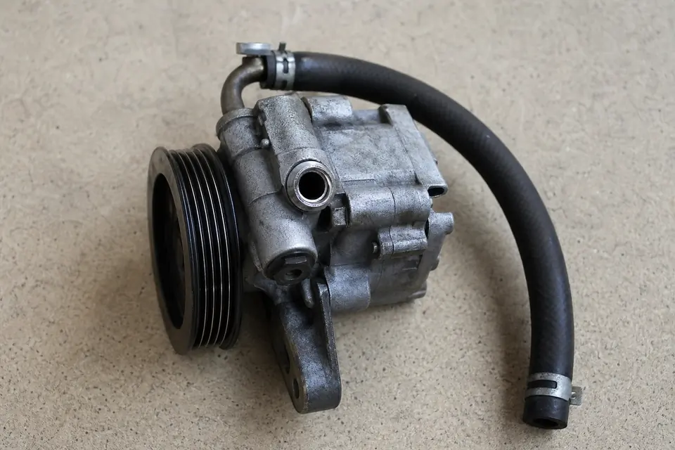 Hydraulic power steering pump with attached hose