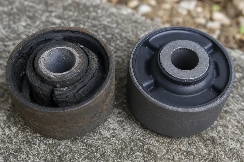 Worn and replacement suspension bushings side by side