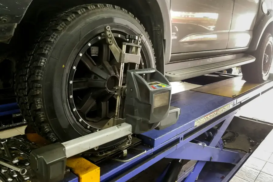 Wheel alignment equipment attached to a vehicle's wheel during an alignment check.